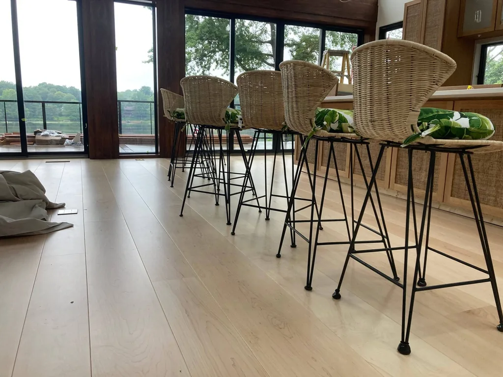 Carlisle wide-plank hardwood in a kitchen with wicker barstools