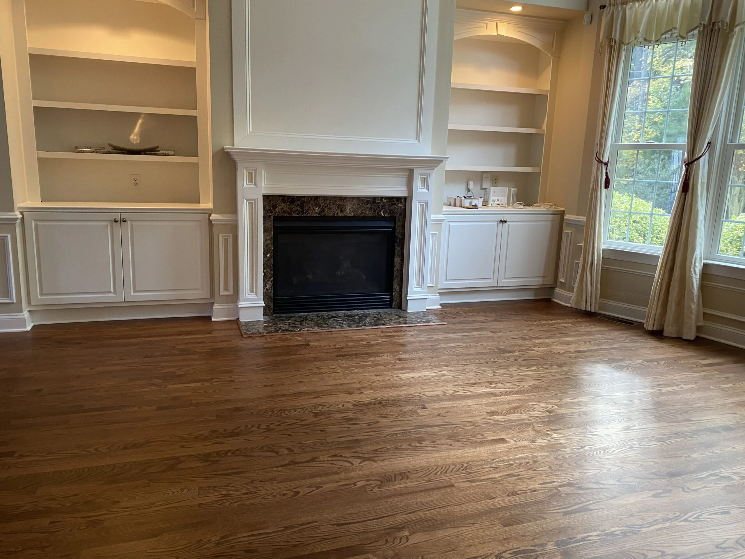 Hardwood floor around a fireplace
